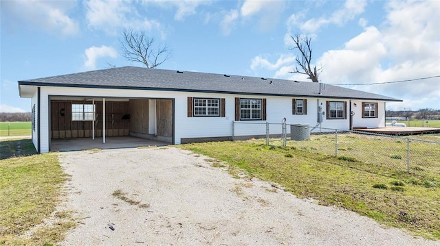 view of front facade featuring driveway and fence