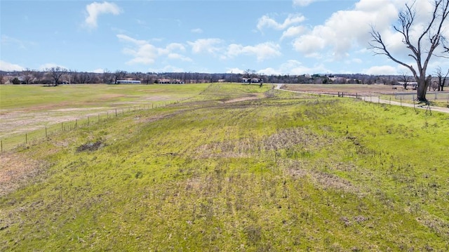 view of yard featuring a rural view and fence