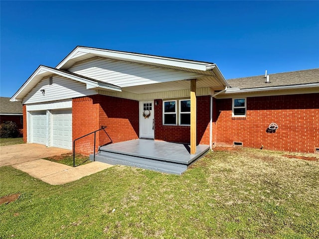 rear view of house with brick siding, a porch, driveway, a yard, and an attached garage