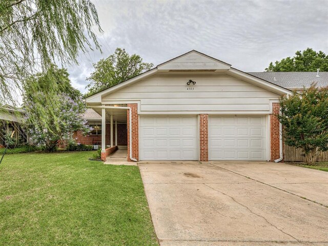 4303 N Redmond Ave, Bethany, OK 73008 - view of front facade featuring brick siding, driveway, a garage, and a front lawn