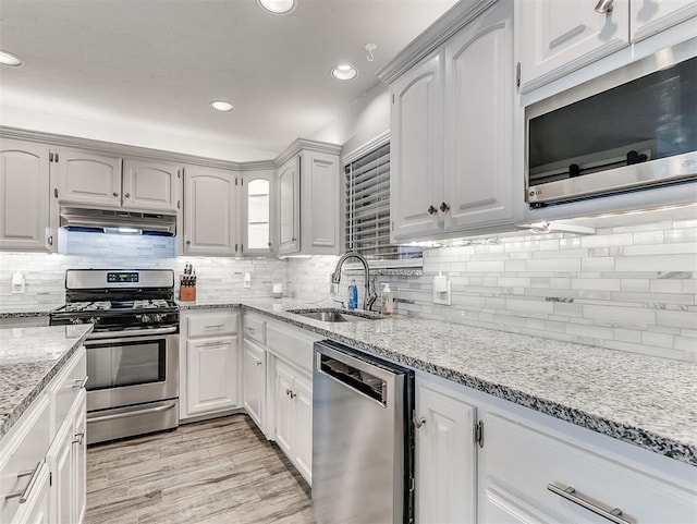 4303 N Redmond Ave, Bethany, OK 73008 - kitchen with stainless steel appliances, under cabinet range hood, backsplash, and recessed lighting