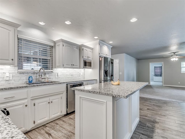 4303 N Redmond Ave, Bethany, OK 73008 - kitchen featuring appliances with stainless steel finishes, recessed lighting, decorative backsplash, a kitchen island, and ceiling fan