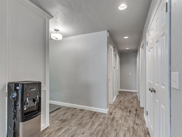 4303 N Redmond Ave, Bethany, OK 73008 - hallway featuring light wood-style flooring, recessed lighting, and a textured ceiling