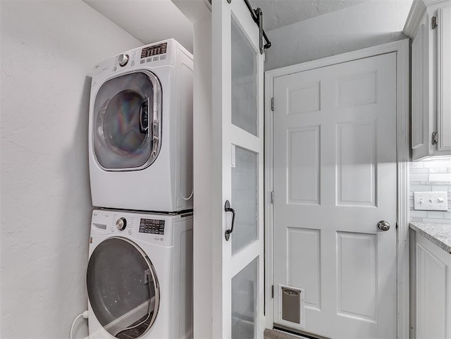 4303 N Redmond Ave, Bethany, OK 73008 - laundry room with stacked washing machine and dryer and a barn door