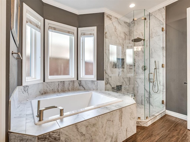 full bathroom with a marble finish shower, crown molding, a garden tub, and wood finished floors