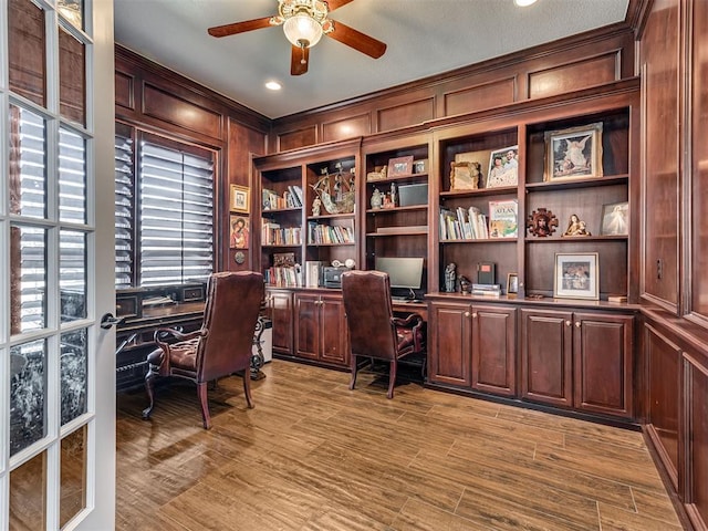 home office featuring wood finished floors and a ceiling fan