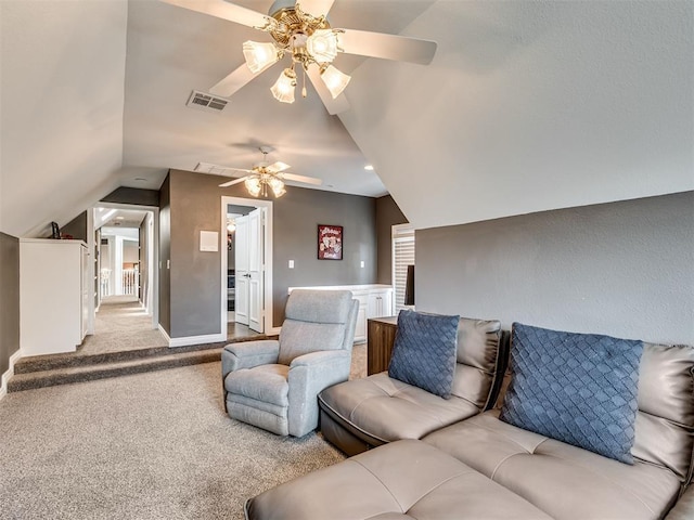 carpeted living room featuring visible vents, lofted ceiling, and baseboards