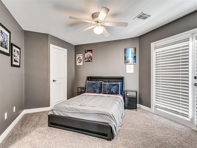 carpeted bedroom with a ceiling fan, baseboards, and visible vents