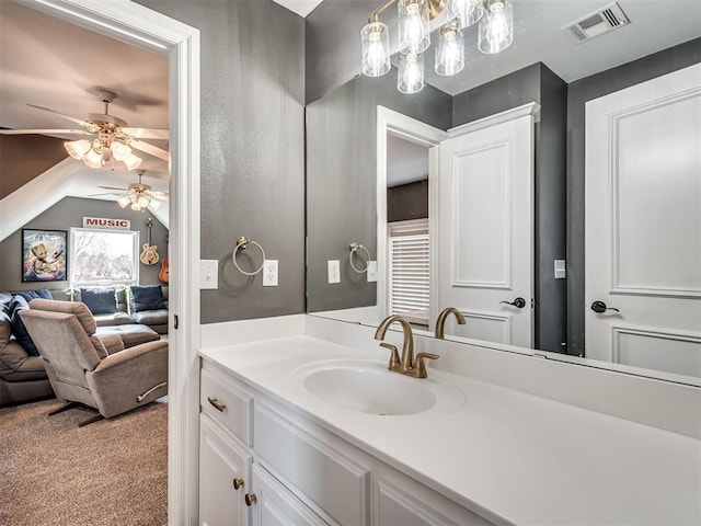 bathroom featuring visible vents, ceiling fan, vanity, and vaulted ceiling