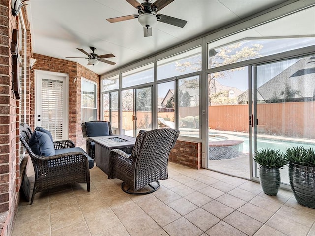 sunroom featuring plenty of natural light and ceiling fan