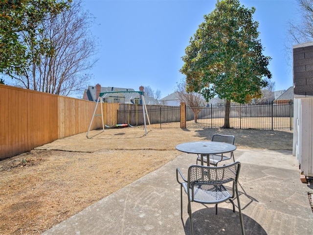 view of patio / terrace with a playground and a fenced backyard