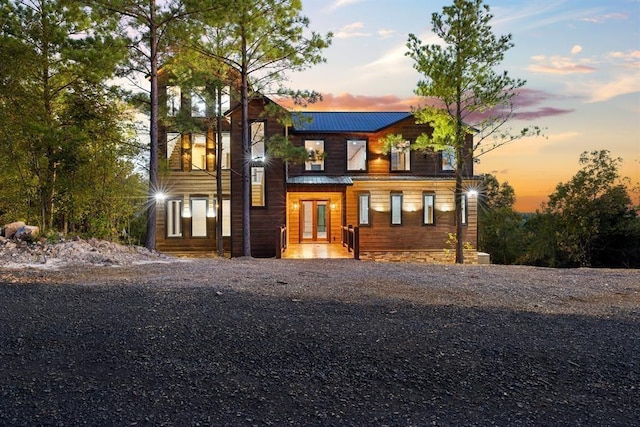 view of front of house featuring metal roof and gravel driveway