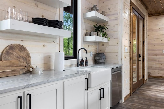 bar featuring a sink, wooden walls, wood ceiling, and dark wood finished floors