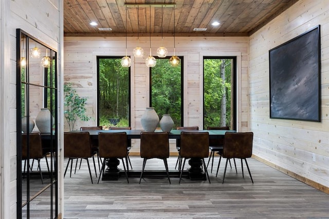 dining area featuring recessed lighting, wooden walls, wood ceiling, and wood finished floors