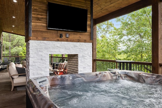 wooden deck with a hot tub