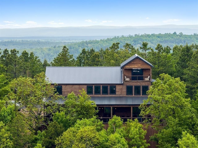 exterior space featuring a wooded view