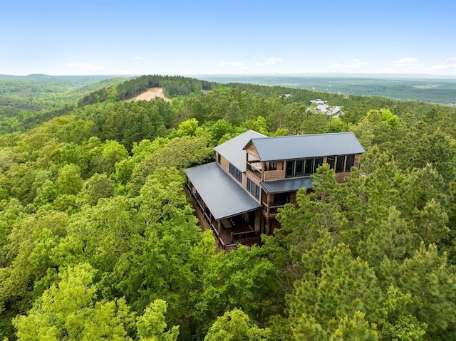 drone / aerial view featuring a forest view