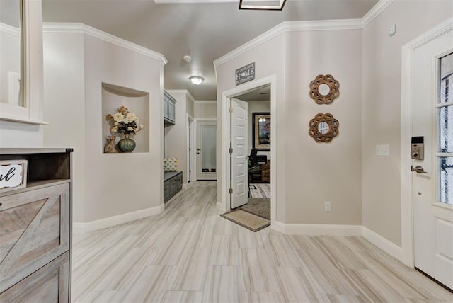 foyer entrance featuring baseboards, crown molding, and light wood finished floors