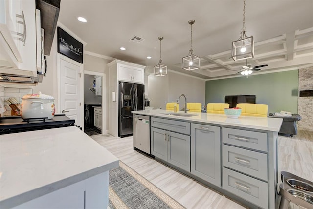 kitchen with dishwasher, light countertops, black fridge with ice dispenser, coffered ceiling, and a sink