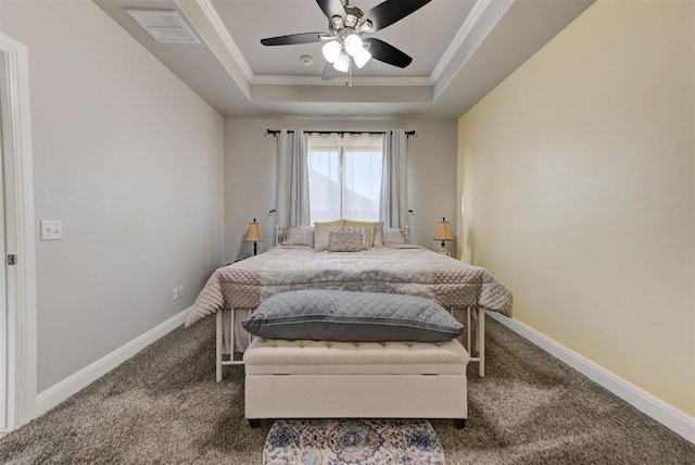 carpeted bedroom with a tray ceiling, baseboards, ornamental molding, and a ceiling fan