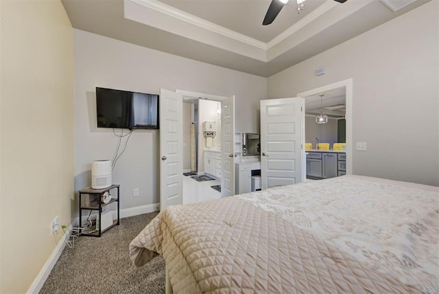 carpeted bedroom featuring baseboards, a sink, crown molding, ensuite bathroom, and a raised ceiling