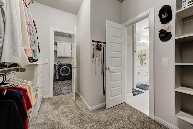 spacious closet with carpet floors and washer and clothes dryer