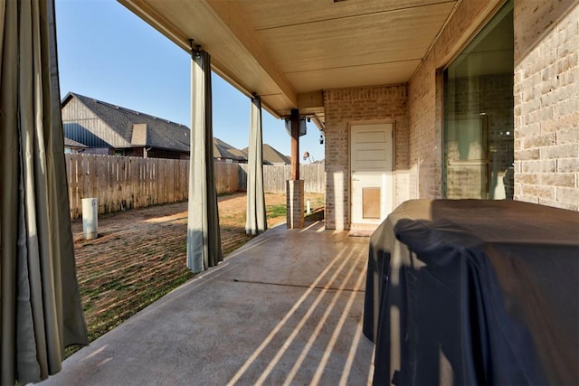 view of patio with grilling area and a fenced backyard