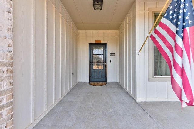 view of exterior entry featuring board and batten siding