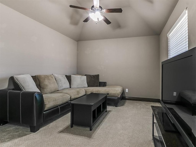 living room with baseboards, lofted ceiling, light colored carpet, and ceiling fan