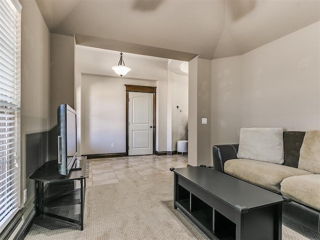 living room featuring light carpet, baseboards, and vaulted ceiling