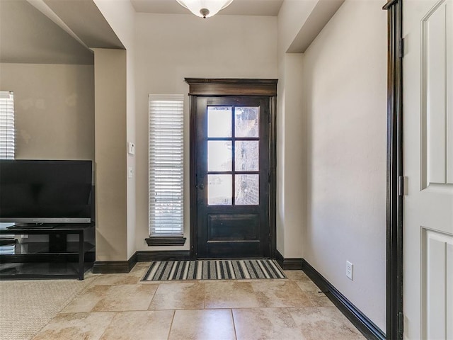 entrance foyer with baseboards and tile patterned flooring