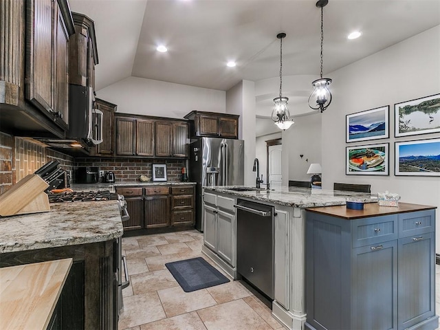 kitchen featuring tasteful backsplash, light stone counters, dishwashing machine, stainless steel refrigerator with ice dispenser, and a sink