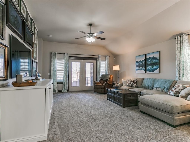 living room with ceiling fan, vaulted ceiling, french doors, and light carpet