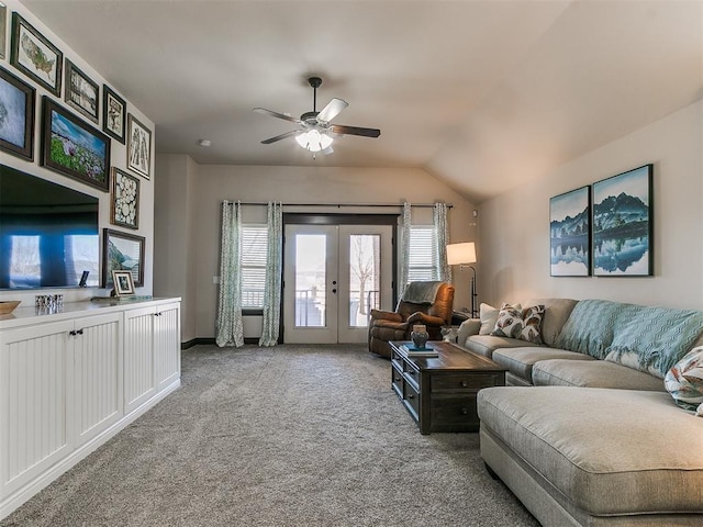 carpeted living area featuring french doors, lofted ceiling, and a ceiling fan