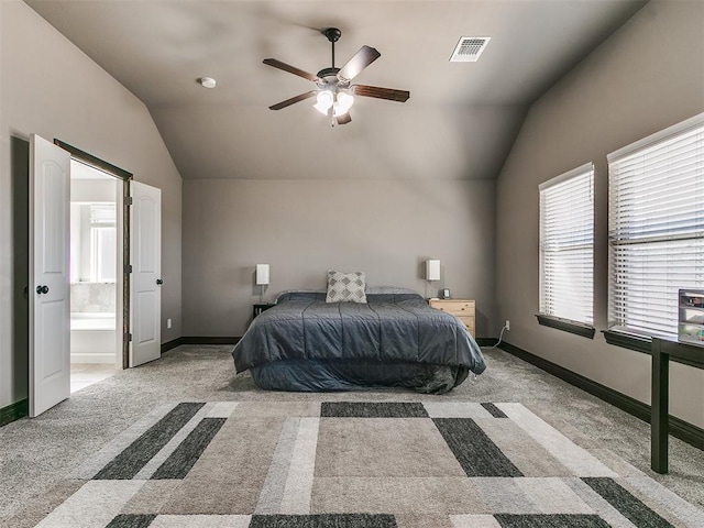 carpeted bedroom featuring visible vents, baseboards, and vaulted ceiling