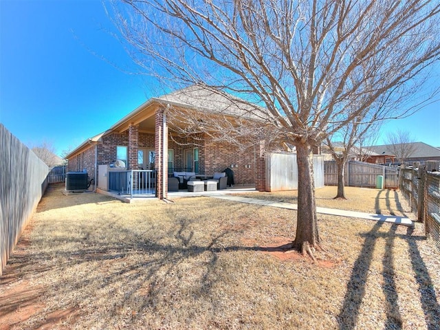 back of house with a patio area, central AC unit, brick siding, and a fenced backyard