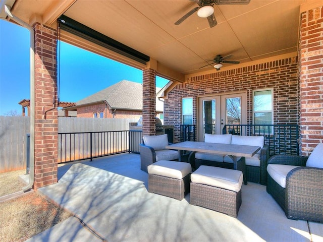 view of patio with an outdoor living space, a ceiling fan, and fence