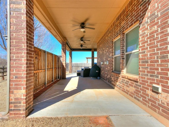 view of patio / terrace featuring a ceiling fan and fence