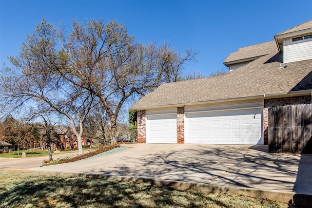 garage with driveway and fence