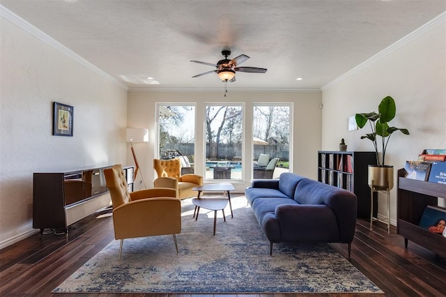 living area with ornamental molding, baseboards, a ceiling fan, and hardwood / wood-style flooring