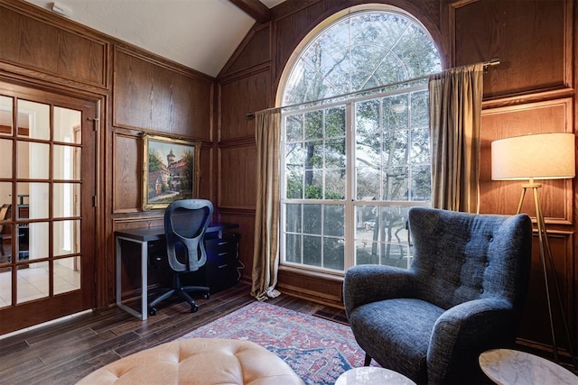 office space featuring vaulted ceiling, wood finished floors, and wood walls