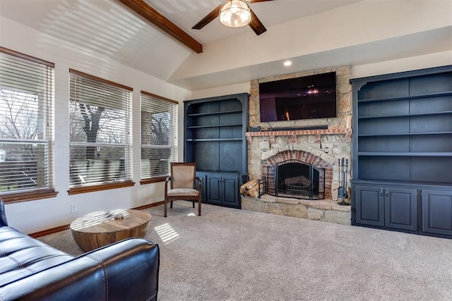 living room with a fireplace, vaulted ceiling with beams, ceiling fan, and carpet flooring