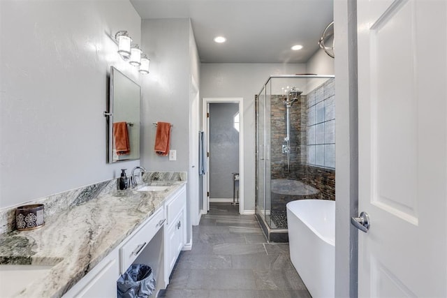 full bath with recessed lighting, a freestanding tub, a stall shower, and vanity