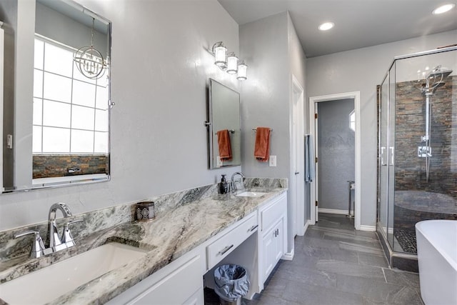 full bath with a sink, double vanity, and a shower stall