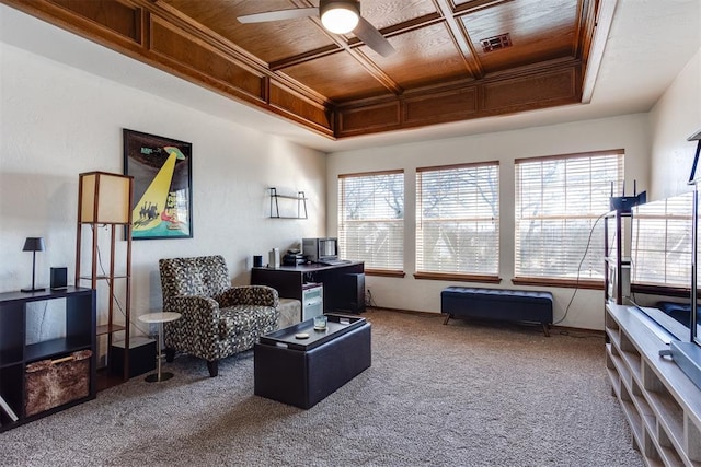 interior space featuring a ceiling fan, visible vents, coffered ceiling, ornamental molding, and wooden ceiling