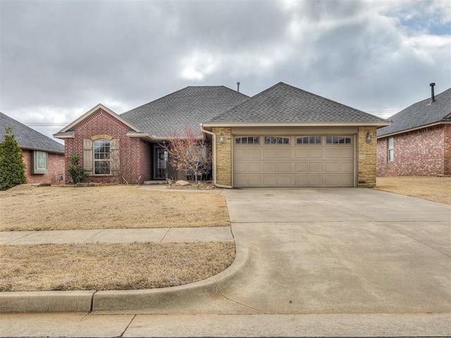 single story home featuring brick siding, an attached garage, a shingled roof, and driveway