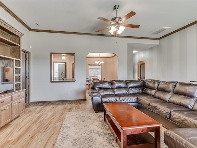 living room with arched walkways, visible vents, ceiling fan with notable chandelier, and ornamental molding