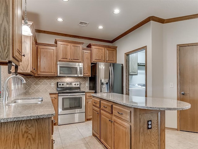 kitchen featuring light tile patterned floors, a sink, decorative backsplash, appliances with stainless steel finishes, and crown molding