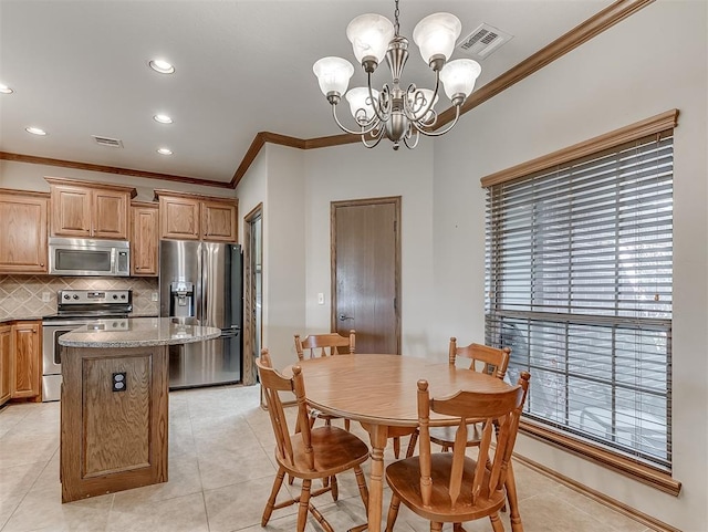 dining area with an inviting chandelier, crown molding, light tile patterned floors, and visible vents