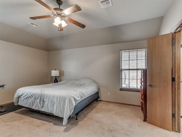 bedroom featuring light carpet, visible vents, lofted ceiling, and baseboards